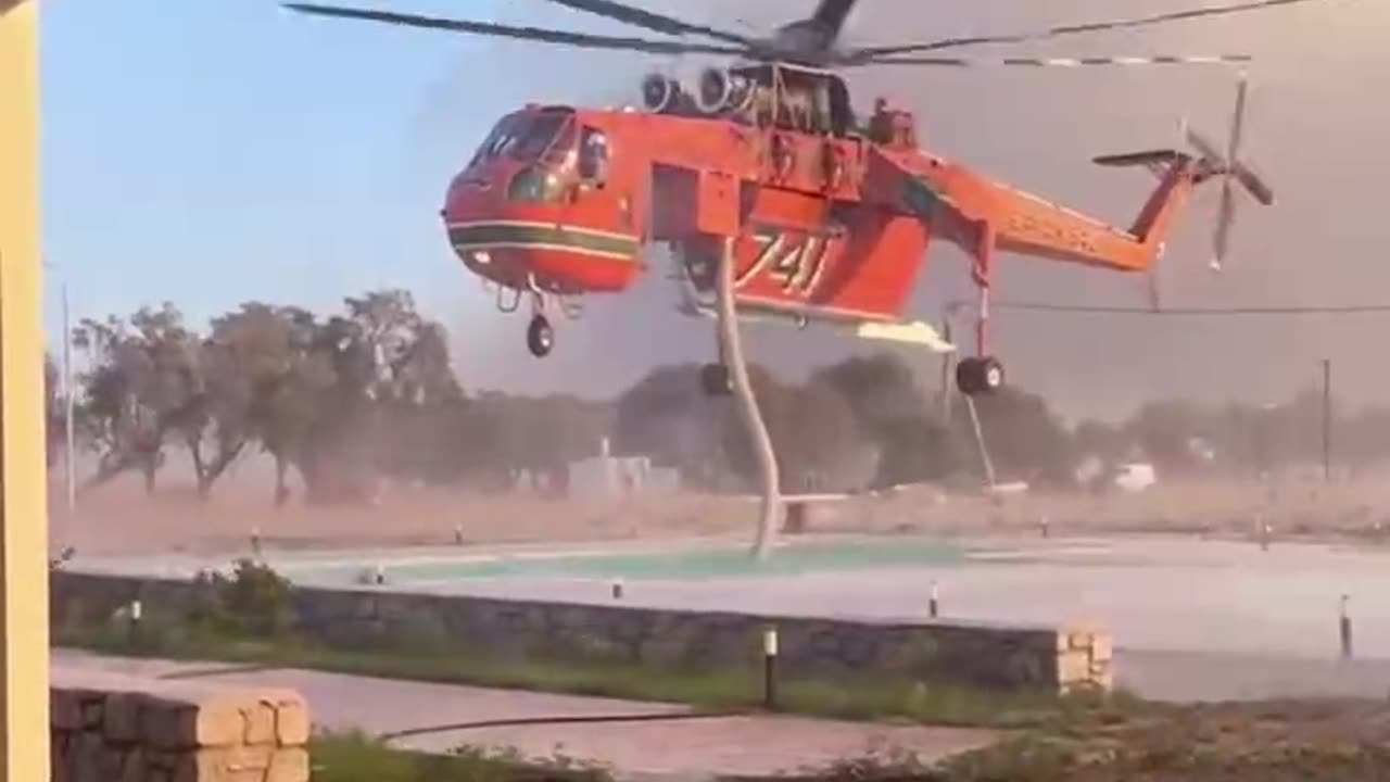 Helicopter extinguising forest fires on Rhodes Island