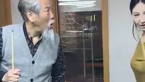 "Generations in Play: Grandfather and Granddaughter Share an Indoor Game 🏓👴👧 #FamilyBonding