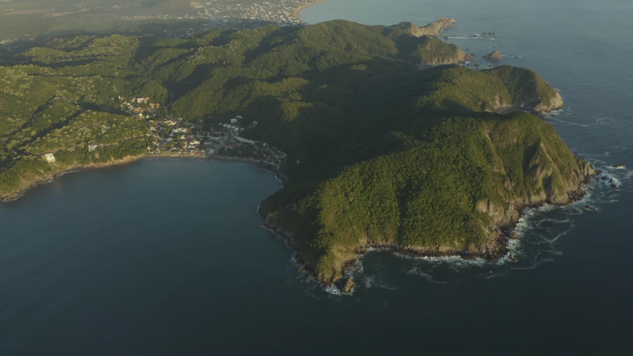 Large island with mountainous relief covered with trees and plants