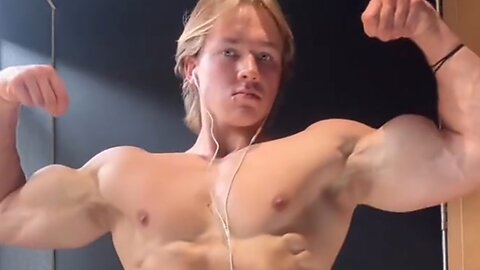 Young aesthetic bodybuilder flexing muscles