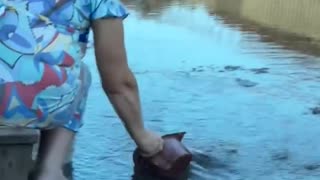 Old Woman Drinking from Puddles in Russian Occupied Makiivka
