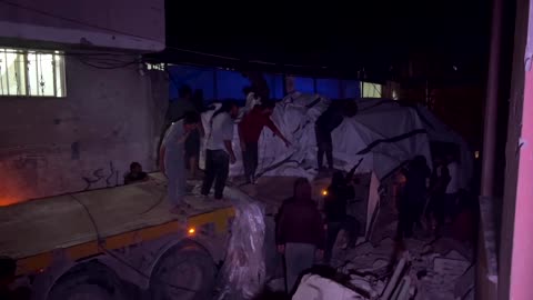 Palestinians unload flour from aid truck in Khan Younis