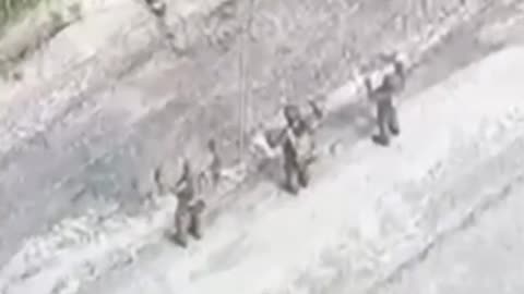 Russian Soldiers Walk Out of Forest, Toss Their Rifles and Surrender in