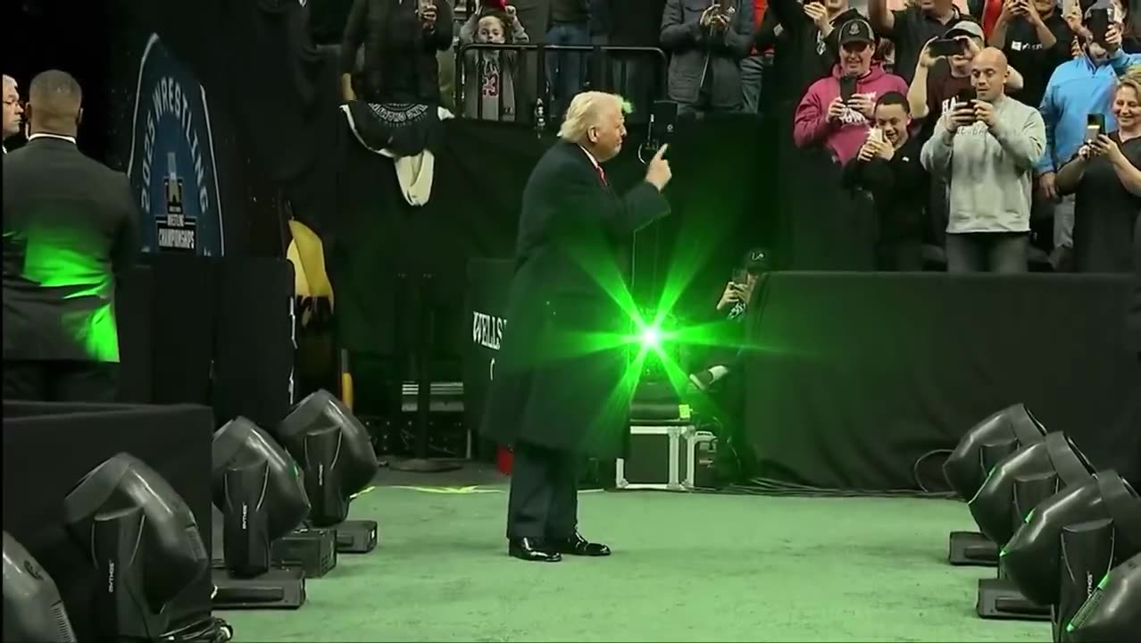 President Trump enters the Wells Fargo Center arena for the Division I NCAA wrestling championships