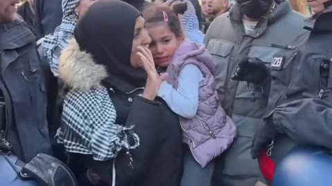German police detain a woman and her crying children