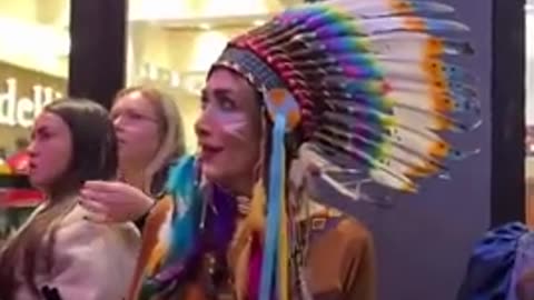 man dressed as a woman attacks a woman dressed as a native American