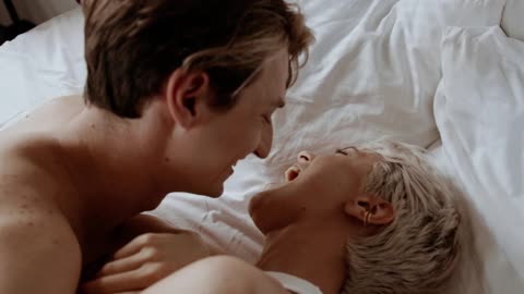 Couple Laughing and Kissing in Bed, Having fun as lovers
