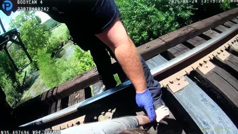 Body cam shows pedestrian rescued after being struck, pinned by train