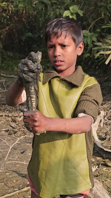 Hand fishing by village boy
