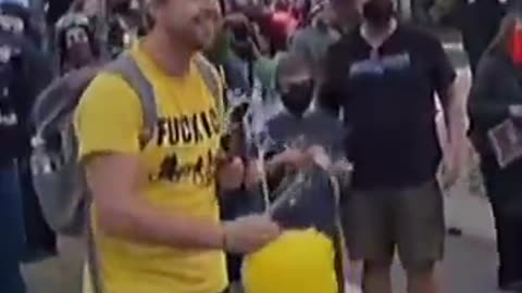 Leftists cheer and high-five a masked child stabbing an effigy of President Trump.