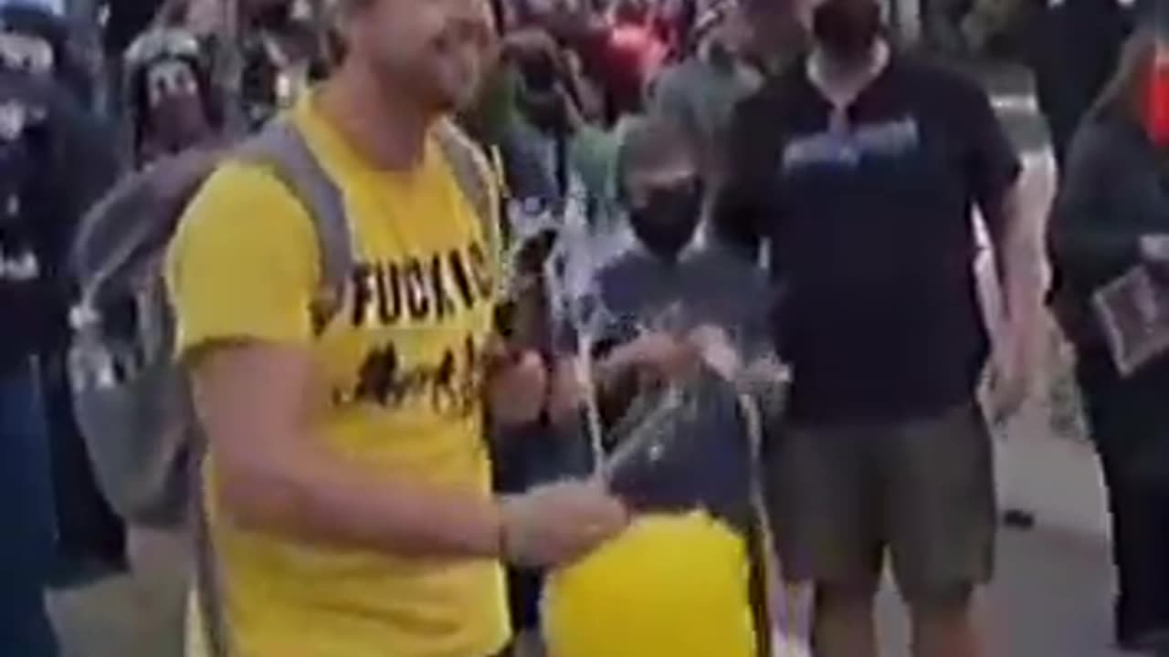 Leftists cheer and high-five a masked child stabbing an effigy of President Trump.