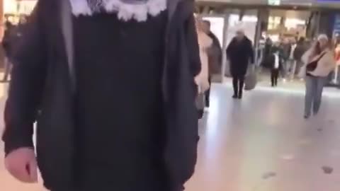 A Muslim woman spits on an elderly German man while his Muslim friend