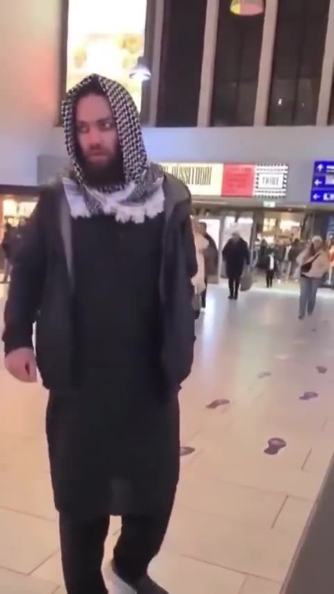 A Muslim woman spits on an elderly German man while his Muslim friend