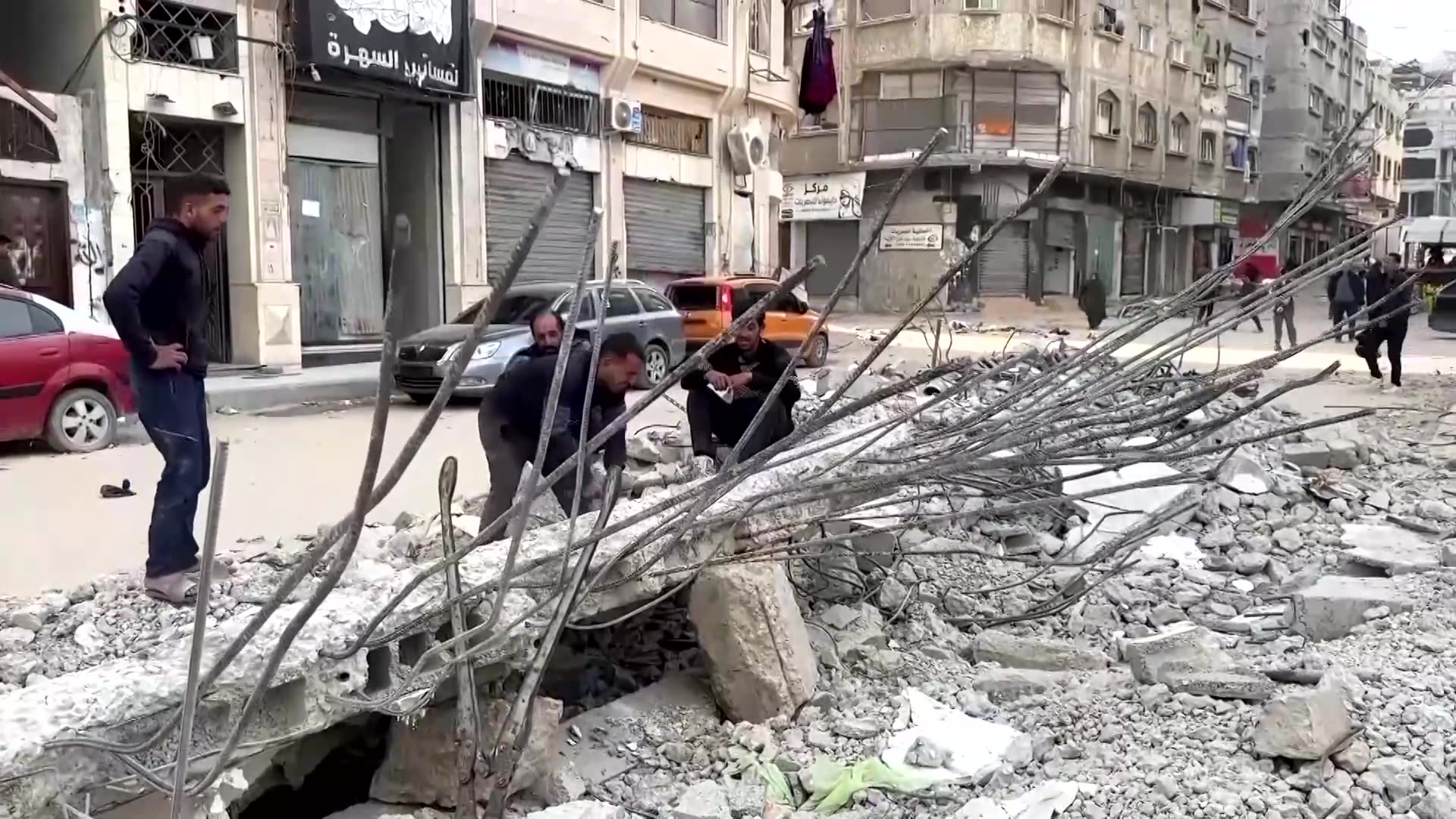 Gazans pull iron bars from rubble to make tents and eke a living