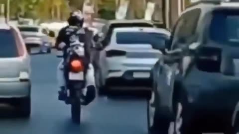 Motorcyclist Navigates Traffic and Faces a Sudden Fall