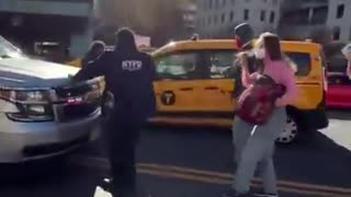 ICE protester literally jumps onto the hood of a moving vehicle using lights & sirens.