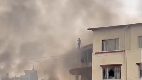 Nepal unrest people tearing the flag
