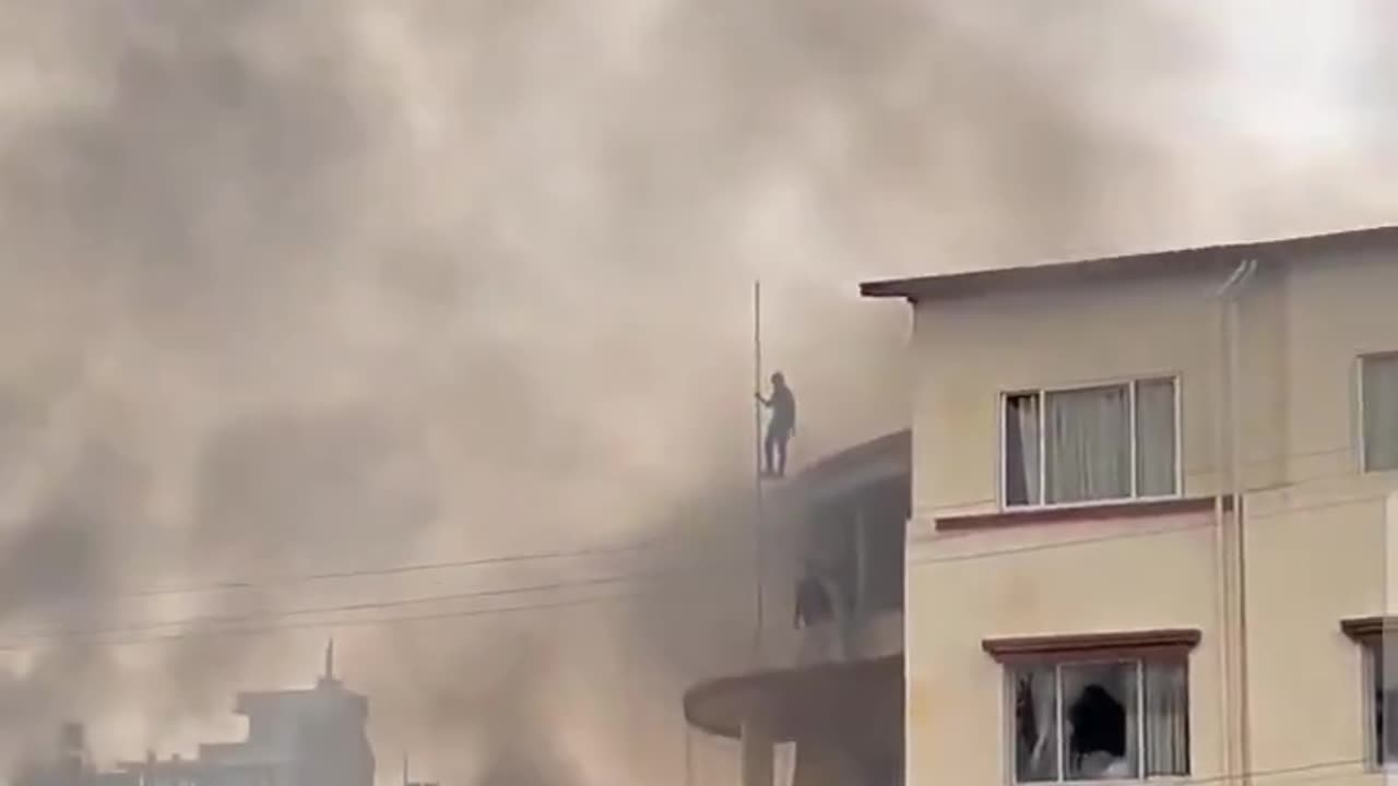 Nepal unrest people tearing the flag