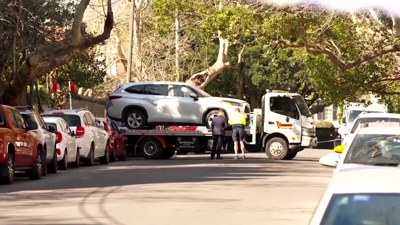 Driver arrested after ramming car into Russian consulate in Sydney