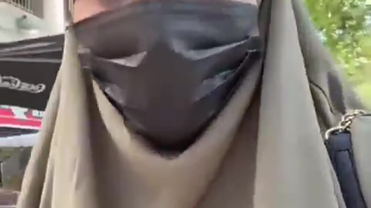 She's very angry because a police officer asked her to remove her mask for a routine check.