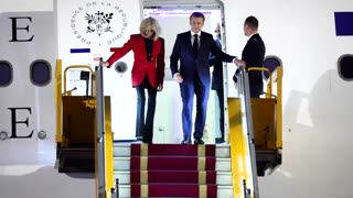 Macron's face appears to be shoved by wife in Vietnam