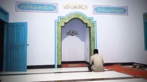 "A Quiet Atmosphere in the Mosque's Mihrab with a Worshipper Praying"