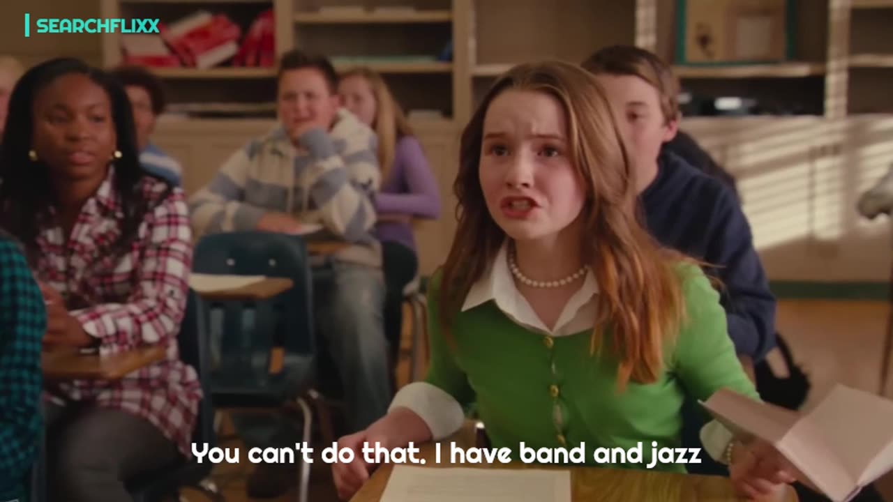 Lazy teacher goes back to teaching kids—not out of passion, but to fund her dream boob job.