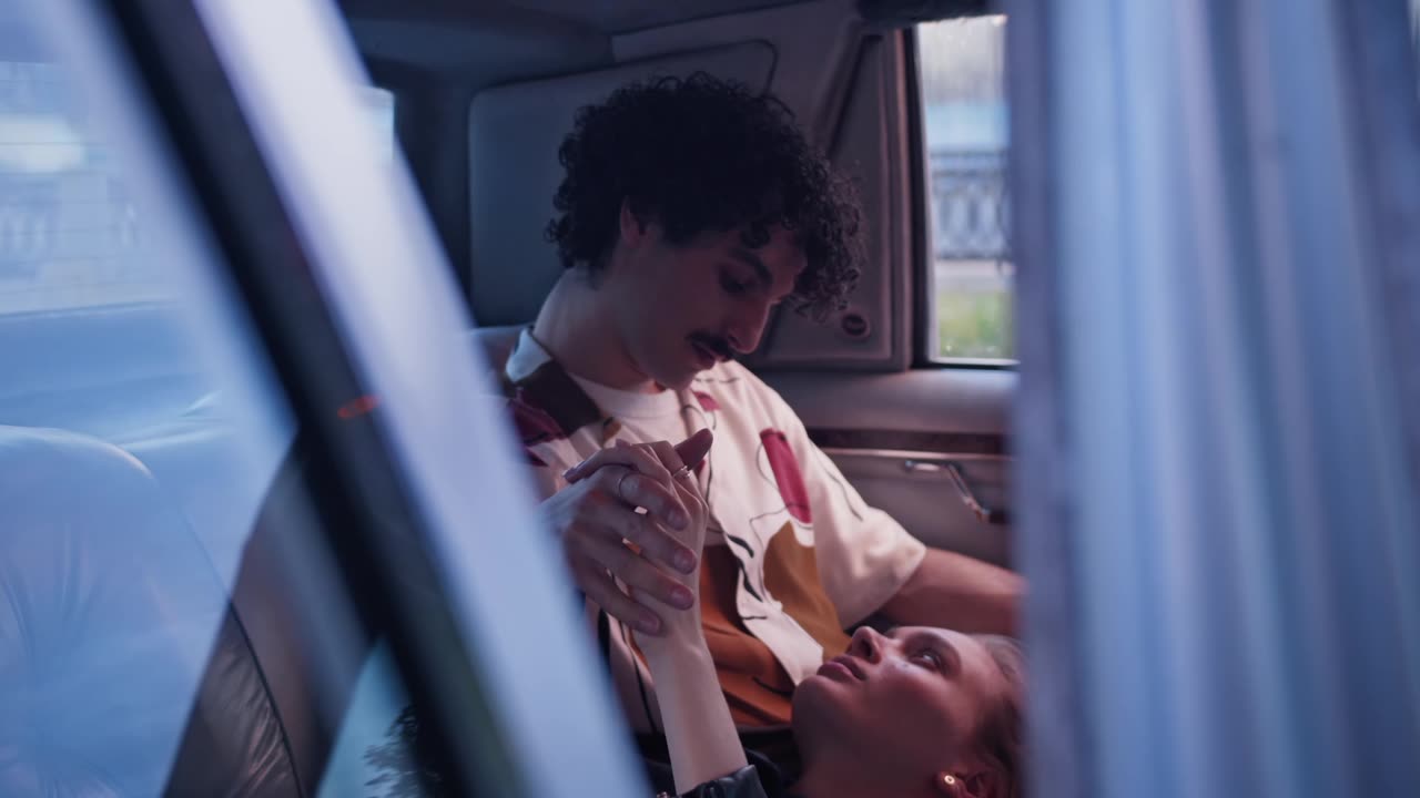 Lovely Couple Holding Hands Inside the Car
