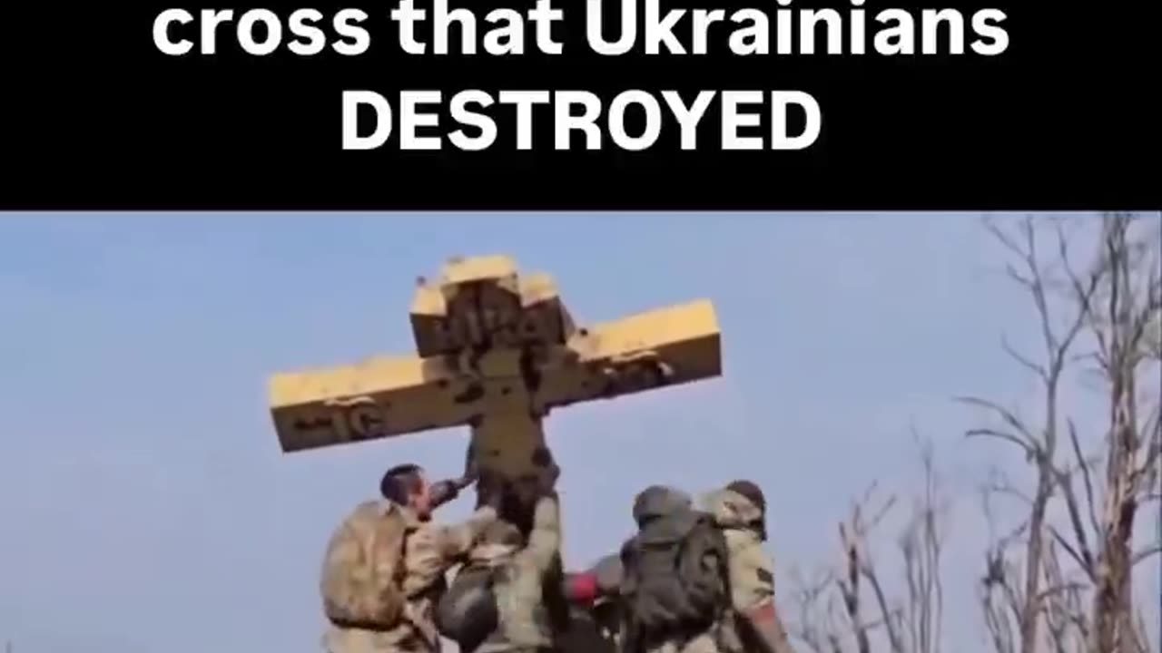 At the Same Time, Russian Soldiers Raise a Cross Damaged in Combat