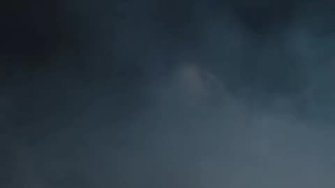 Freaky scary clown in the fog laughing