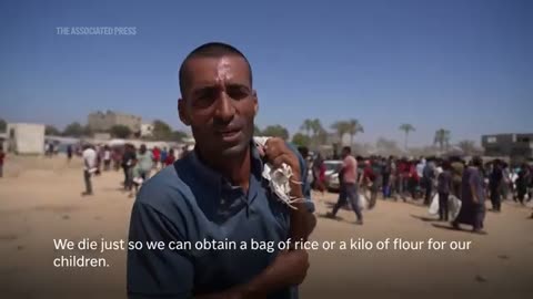 Palestinians in central Gaza run towards air dropped food aid