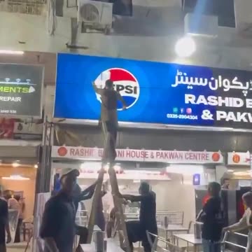 Protesters in Pakistan’s Karachi remove Pepsi logos22