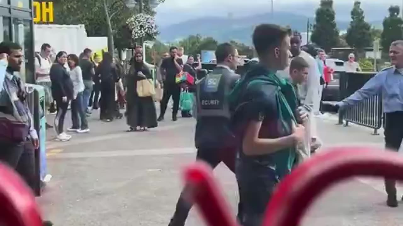 Indian security guard attacks a young Irish fella that was being subdued by his colleague.