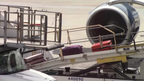 Luggage Being Unloaded from the Plane Creative Commons Stock Video