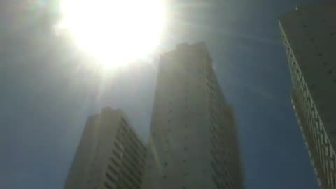 3 skyscrapers get all the heat from a big summer sun, the buildings are big [Nature & Animals]