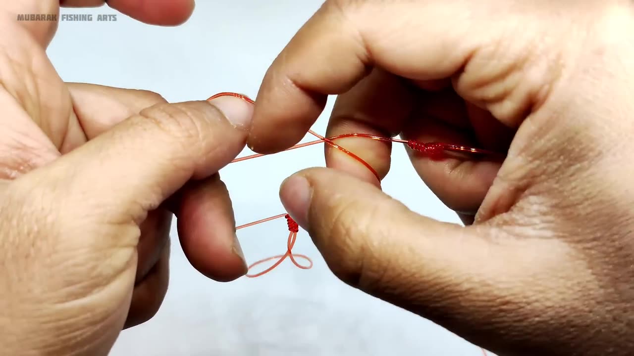 How to make a chain of fishing hooks with two hooks.