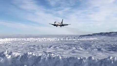 Nolinor's B737-200C aircraft landing on a snowy runway