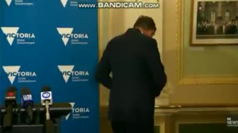 Daniel Andrews adjusts his glasses.
