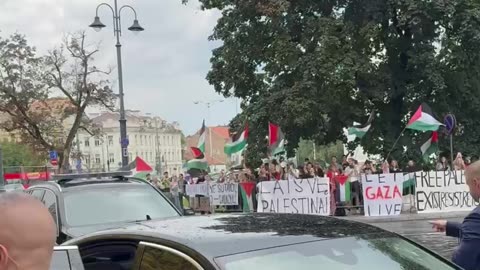Under heavy security Israeli President Isaac Herzog passes by a pro-Hamas protest