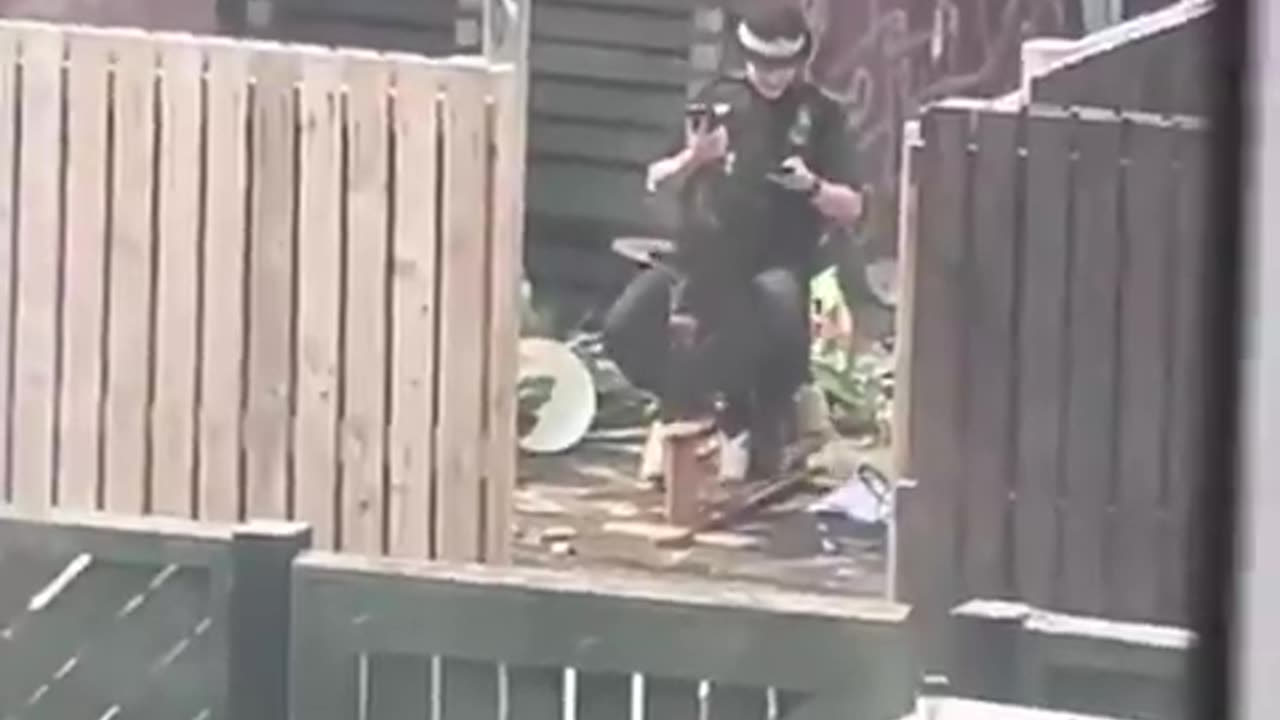 British Policewoman rocking back and forth on a rocking horse whilst playing on her phone