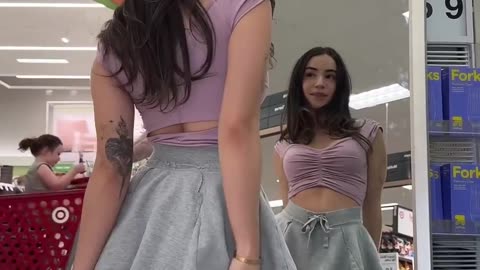 a young girl shakes her butt in front of the mirror