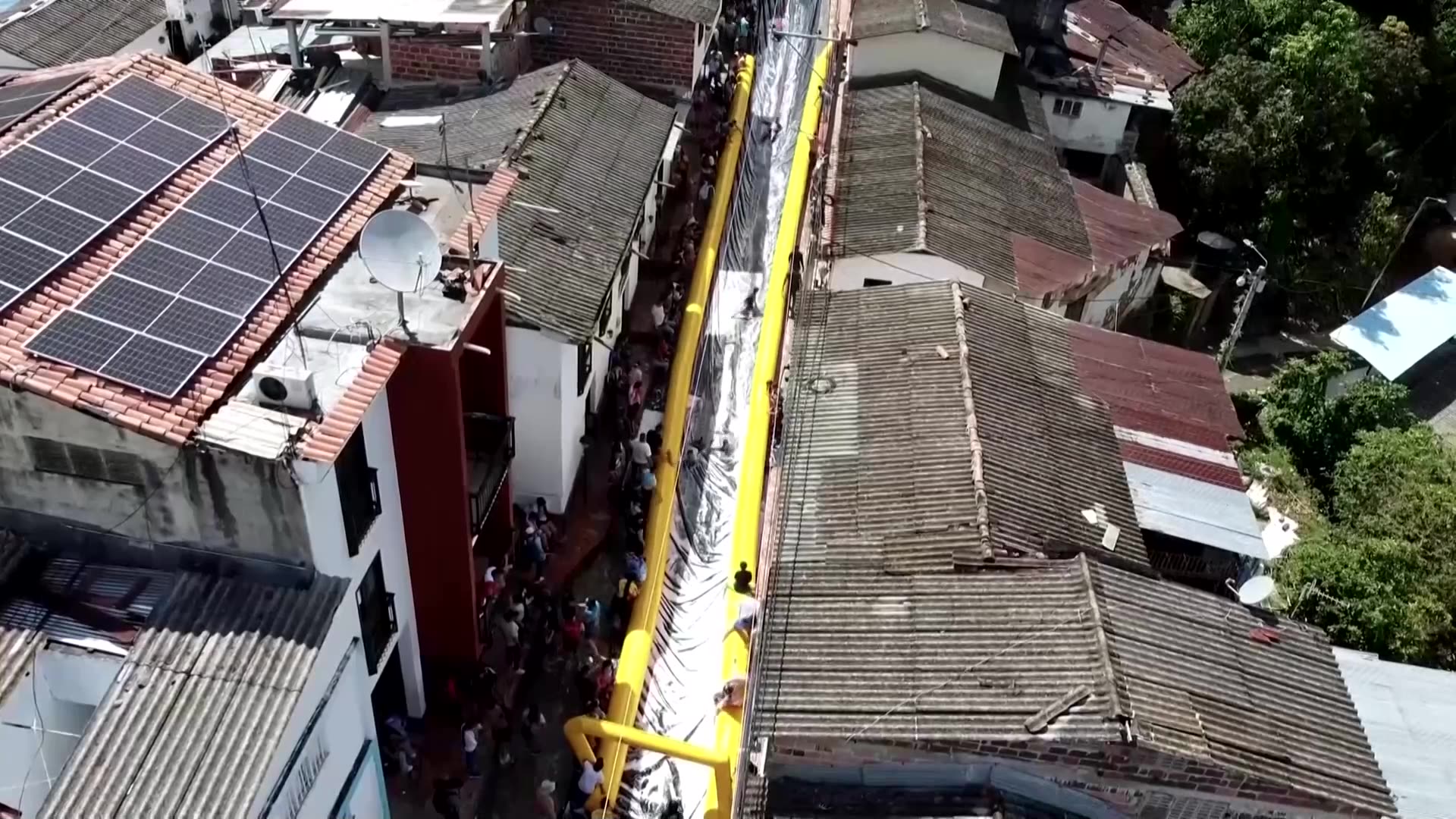 Colombian town turns main street into giant slide to boost image