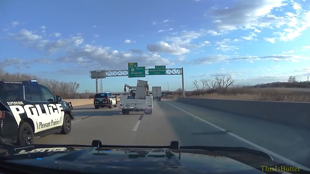 Dash camera video shows the truck, hauling a refrigerator, forced to the side of the freeway