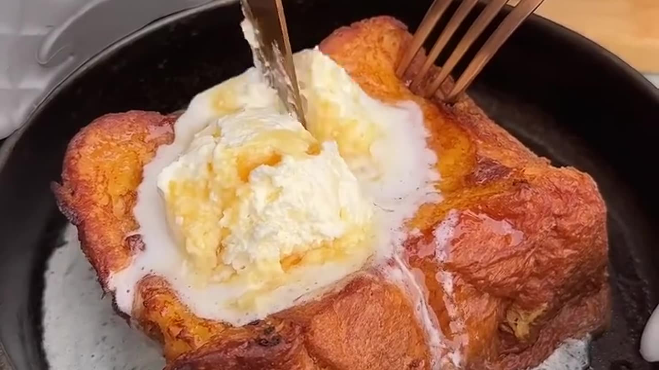 Making a milky fluffy toast for breakfast with vanilla ice cream and honey