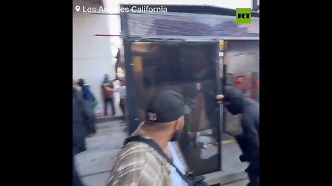 07.06.25 Masked thugs wreck ICE detention center as militarized riot cop stands ready to shoot.