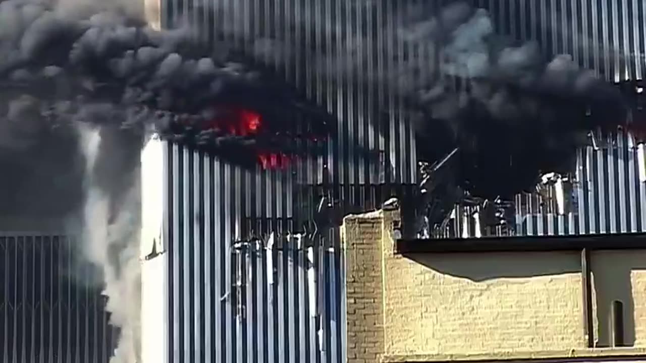 Edna Cintron waving from the gaping hole left by Flight 11’s impact on the World Trade Center September 11, 2001
