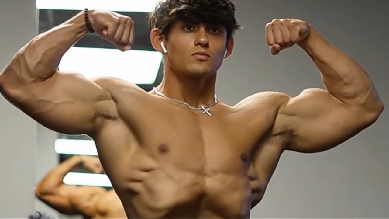 Young man flexing muscles