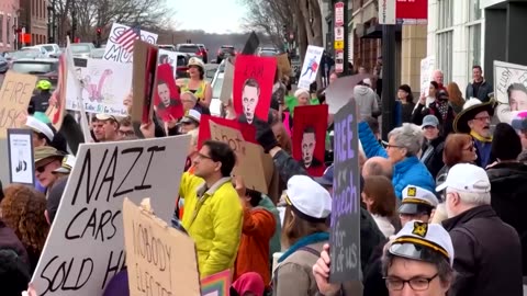 Anti-Musk protesters dance outside Washington DC Tesla showroom