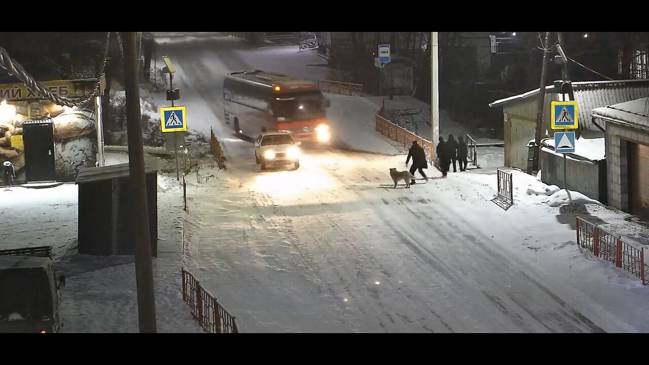 Bus in Russia unable to stop on snow down incline, tries to aim for empty lane