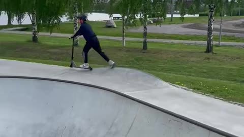 Boy Faceplants While Scootering In Skatepark